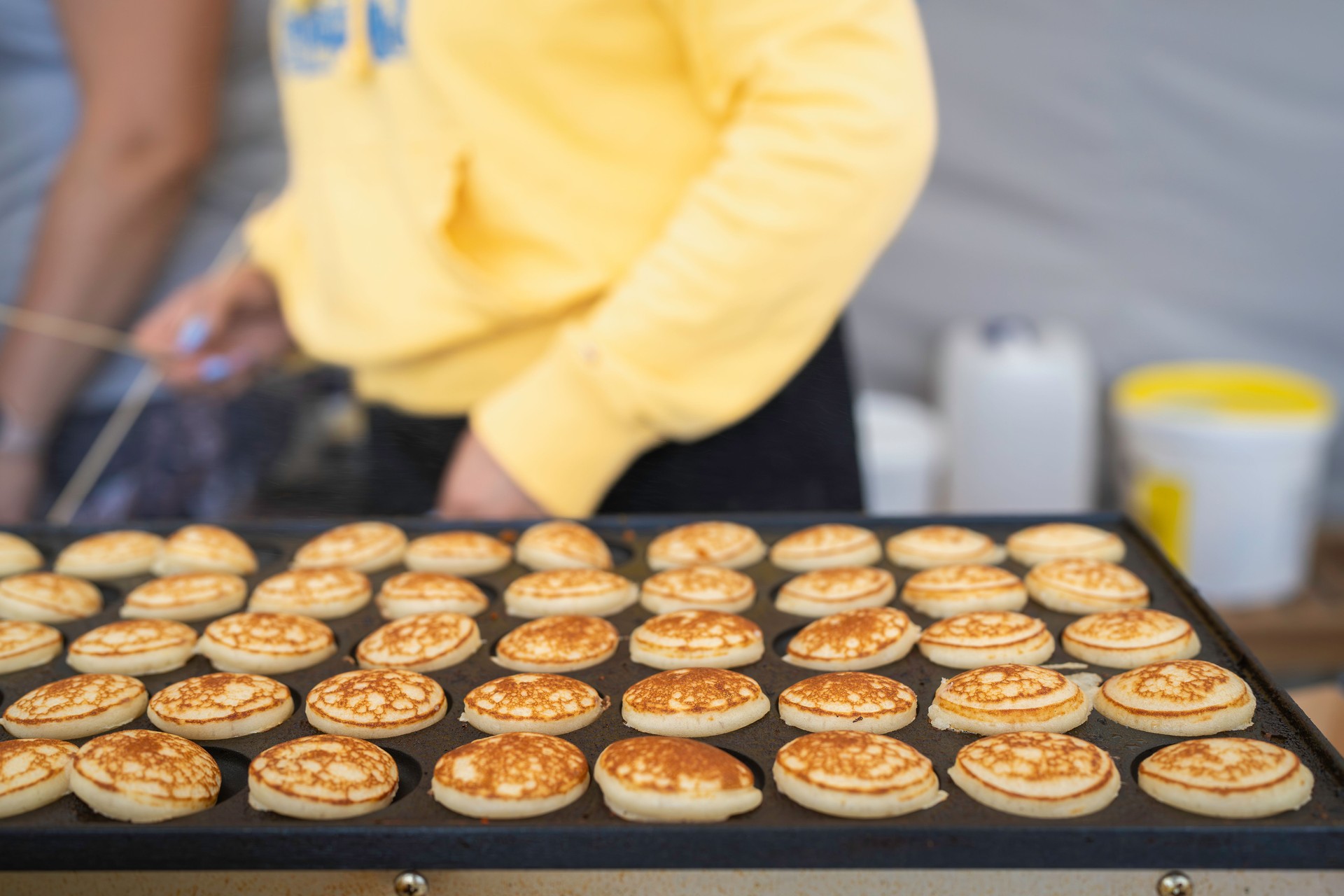 Dutch small, fluffy pancakes, made on hot iron plate.